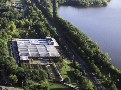 An arial photo of a building surrounded by lush greenery. 